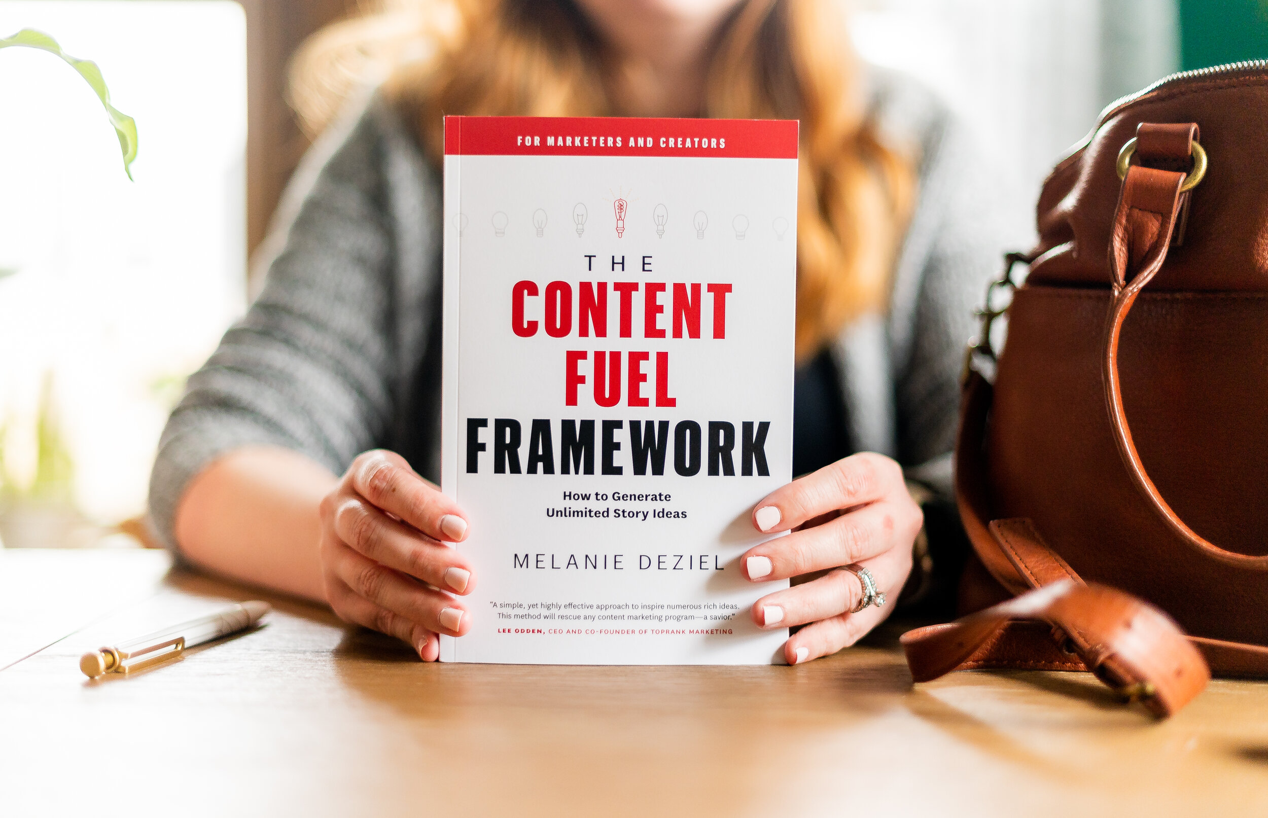 woman holding book the content fuel framework